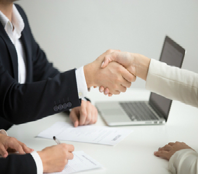 Two persons shaking hands following interview